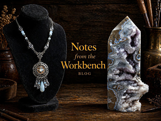 Moody workbench scene featuring a silver pendant necklace on a black display and a druzy agate tower, with “Notes from the Workbench” in gold lettering.